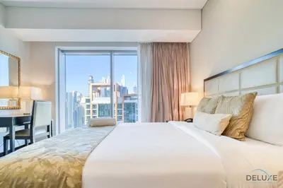 a bedroom with a large bed with a large window at Pristine 1BR in The Address Residences Dubai Marina by Deluxe Holiday Homes in Dubai