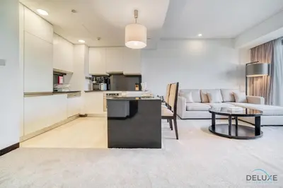 a kitchen and living room with a couch and a table at Pristine 1BR in The Address Residences Dubai Marina by Deluxe Holiday Homes in Dubai