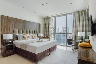 a bedroom with a large bed and a large window at Frank Porter - Bonnington in Dubai