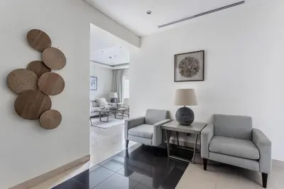 a living room with two chairs and a table at Frank Porter - Bonnington in Dubai
