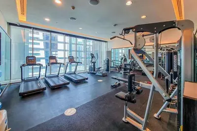 a gym with several tread machines and a large window at Frank Porter - Bonnington in Dubai