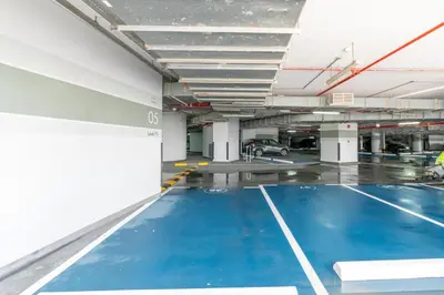 a parking lot with a blue floor in a parking garage at GlobalStay DAMAC Towers by Paramount Business Bay Apartments in Dubai
