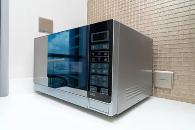 a microwave oven is on a wall at GlobalStay DAMAC Towers by Paramount Business Bay Apartments in Dubai