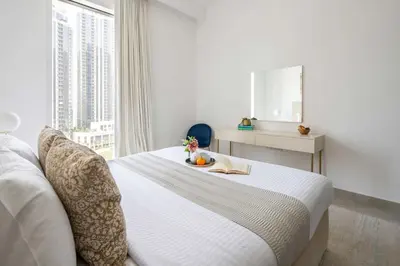 a bedroom with a bed with a plate of fruit on it at Frank Porter - Creek Horizon T2 in Dubai