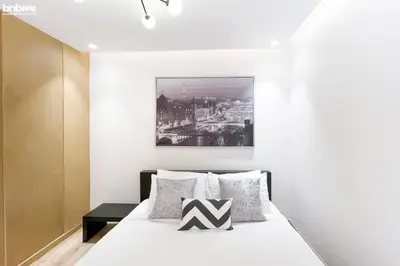 a bedroom with a bed and a painting on the wall at Designer apartment on the Marina Walk in Dubai