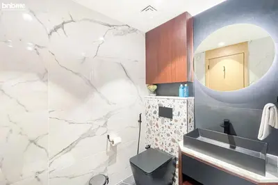 a bathroom with a sink and a mirror at Designer apartment on the Marina Walk in Dubai