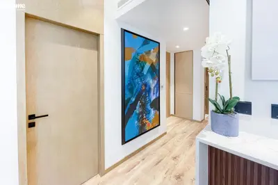 a hallway with a door and a painting on the wall at Designer apartment on the Marina Walk in Dubai