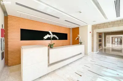 a lobby with a flat screen tv on a wall at Designer apartment on the Marina Walk in Dubai