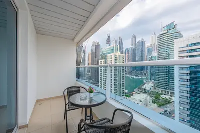 a balcony with a table and chairs and a view of the city at Marco Polo - Find your calm escape in Dubai Marina in Dubai