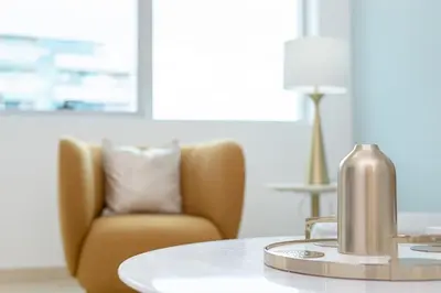 a gold fire hydrant sitting on a table with a chair at Marco Polo - Find your calm escape in Dubai Marina in Dubai