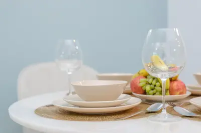 a table with plates and bowls and wine glasses at Marco Polo - Find your calm escape in Dubai Marina in Dubai