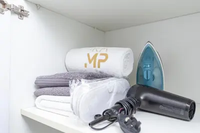 a drying rack with towels and a hair dryer at Marco Polo - Find your calm escape in Dubai Marina in Dubai