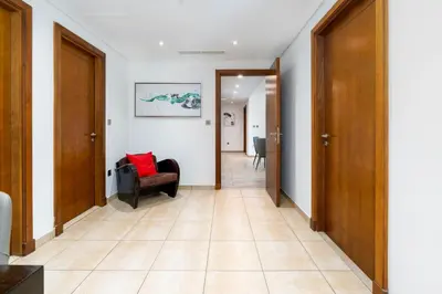 a hallway with a couch and a chair at Ahlan HH - Luxurious Apartment with Beach Access and Sea View at Palm Jumeirah in Dubai