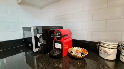 a red mailbox is sitting next to a coffee maker at Marco Polo - Experience beachfront luxury at Bahar 6 JBR in Dubai