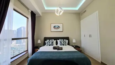 a bedroom with a bed and a large window at Marco Polo - Experience beachfront luxury at Bahar 6 JBR in Dubai