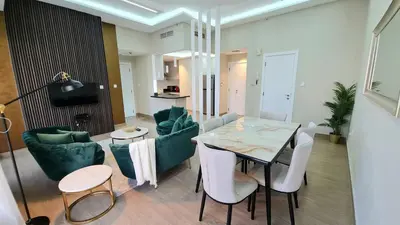 a living room with a table and some chairs at Marco Polo - Experience beachfront luxury at Bahar 6 JBR in Dubai