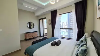 a bedroom with a bed and a large window at Marco Polo - Experience beachfront luxury at Bahar 6 JBR in Dubai