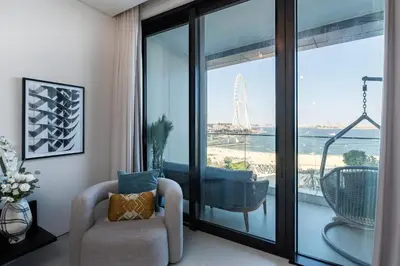 a living room with a chair and a view of the beach at Address JBR Sea View, Jumeirah Beach Residence, Dubai Marina - Mint Stay in Dubai