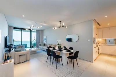 a dining room and living room with a table and chairs at Address JBR Sea View, Jumeirah Beach Residence, Dubai Marina - Mint Stay in Dubai
