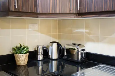 a kitchen counter with a coffee maker and a toaster at HiGuests - Charming Apt in JBR with Balcony by the Beach in Dubai