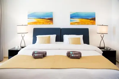 a bedroom with a large bed with two pillows on it at HiGuests - Charming Apt in JBR with Balcony by the Beach in Dubai