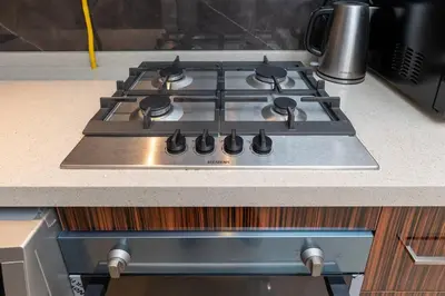 a stove top oven sitting on top of a kitchen counter at White Sage - Elite Residence Studio in Dubai
