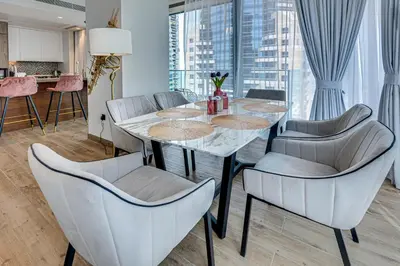 a dining room with a table and chairs at Luxury 2BD apartment in MarinaGate Jumeirah Living in Dubai