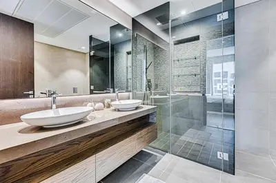 a bathroom with two sinks and a shower at Luxury 2BD apartment in MarinaGate Jumeirah Living in Dubai