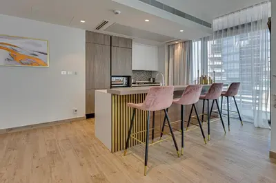 a kitchen with a table and chairs in a room at Luxury 2BD apartment in MarinaGate Jumeirah Living in Dubai