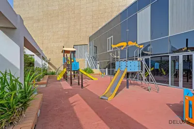 a playground in front of a building at Refreshing 1BR Loft At Sky Garden DIFC By Deluxe Holiday Homes in Dubai