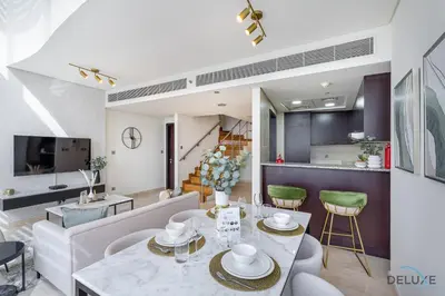 a dining room and living room with a table and chairs at Refreshing 1BR Loft At Sky Garden DIFC By Deluxe Holiday Homes in Dubai