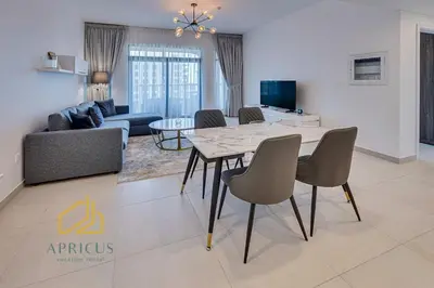 a dining room and living room with a table and chairs at Luxury 1BD apartment in Madinat Jumeirah Living in Dubai