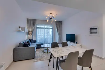 a living room with a table and a couch at Luxury 1BD apartment in Madinat Jumeirah Living in Dubai