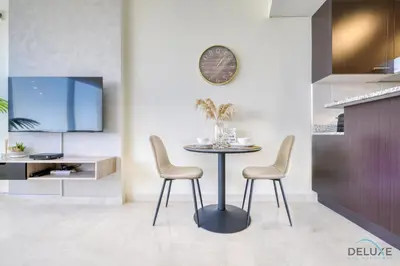 a dining room with a table and two chairs at Calm Studio at Sky Gardens DIFC by Deluxe Holiday Homes in Dubai