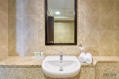 a bathroom with a sink and a mirror at Calm Studio at Sky Gardens DIFC by Deluxe Holiday Homes in Dubai