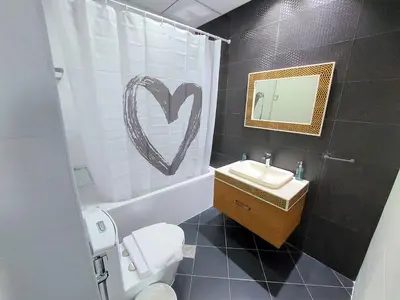 a bathroom with a heart drawn on the shower curtain at Spacious, Economical Apt Near Miralcz Garden in Dubai