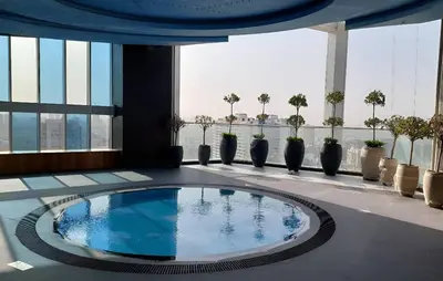 a pool in the middle of a building at Spacious, Economical Apt Near Miralcz Garden in Dubai