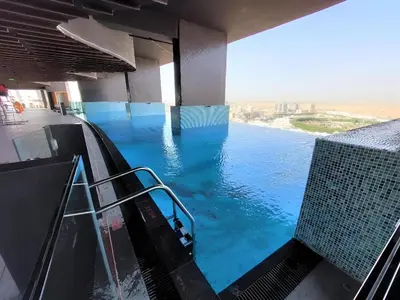 a view of a infinity pool from a hotel room at Spacious, Economical Apt Near Miralcz Garden in Dubai
