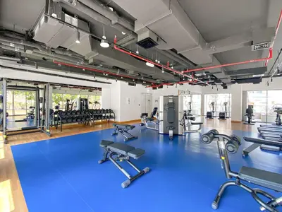a gym with a blue floor and several exercise bikes at Silkhaus Burj Khalifa view large 2BDR in great location in Dubai