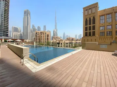 a swimming pool on top of a building with a city skyline at Silkhaus Burj Khalifa view large 2BDR in great location in Dubai