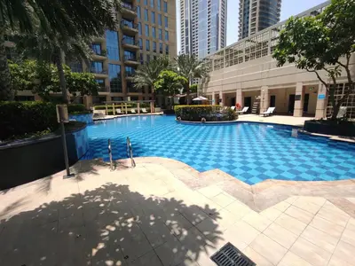a large swimming pool in the middle of a building at Lux BnB Standpoint Tower Burj & Fountain Views in Dubai