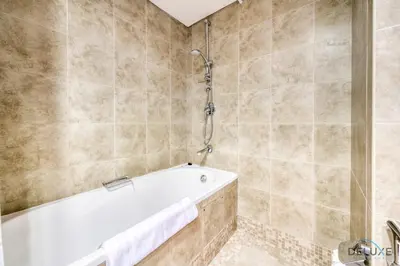 a bathroom with a tub and a shower at Welcoming Studio at Sky Gardens DIFC By Deluxe Holiday Homes in Dubai