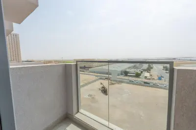a balcony with a view of a parking lot at Luxury Escapes - Cozy Studio In front of Metro Stn - Access to Gym & Pool - Aura Azizi in Dubai