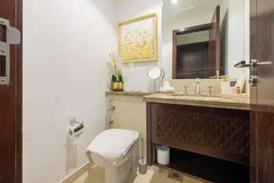 a bathroom with a toilet and a sink and a mirror at FIRST CLASS 3BR with full BURJ KHALIFA VIEW in Dubai