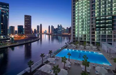 a view of a river in a city at night at DAMAC MAISON PRIVE in Dubai