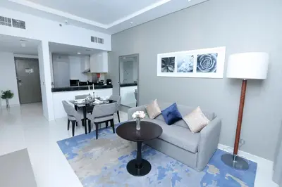 a living room with a couch and a table at DAMAC MAISON PRIVE in Dubai