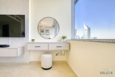 a white bathroom with a mirror and a sink at Great Deal Cozy 1BR with Pool & City Views by Deluxe Holiday Homes in Dubai