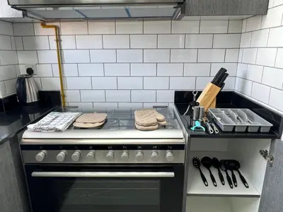a kitchen with a stove with towels on it at Penrose Place Dubai JVC in Dubai