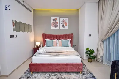 a bedroom with a large bed with a red headboard at Luxury Escapes - Modern studio in West Avenue Dubai Marina in Dubai