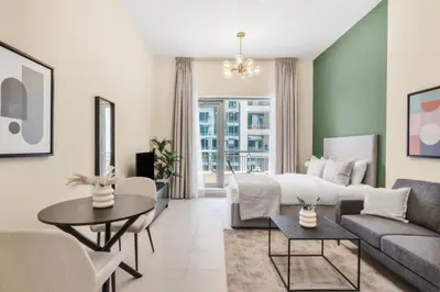 a living room with a bed and a couch at Silkhaus lovely studio with Downtown view in Boulevard central in Dubai